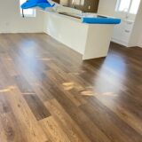 93d2f276d23de3c9812bcd2dfd068f5 rotated Bring a touch of classic sophistication to your home with <strong>English Walnut Oak</strong>. Its rich walnut tones and detailed grain pattern exude elegance, making it a standout option for both traditional and contemporary designs. Designed with <strong>water-resistant flooring</strong> technology, it provides excellent protection against spills and moisture. Perfect for creating warm and inviting spaces, English Walnut Oak is a durable and stylish choice for <strong>laminate wood flooring</strong> enthusiasts.
